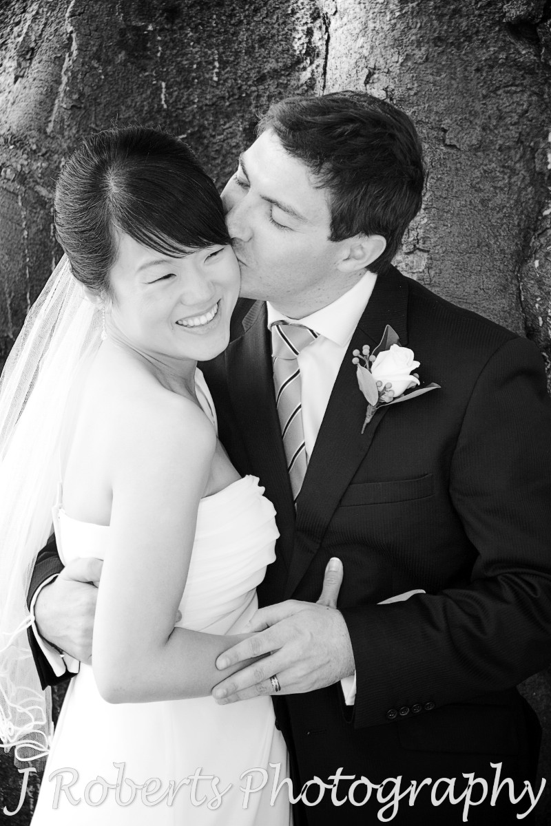 Groom kissing smiling bride - wedding photography sydney